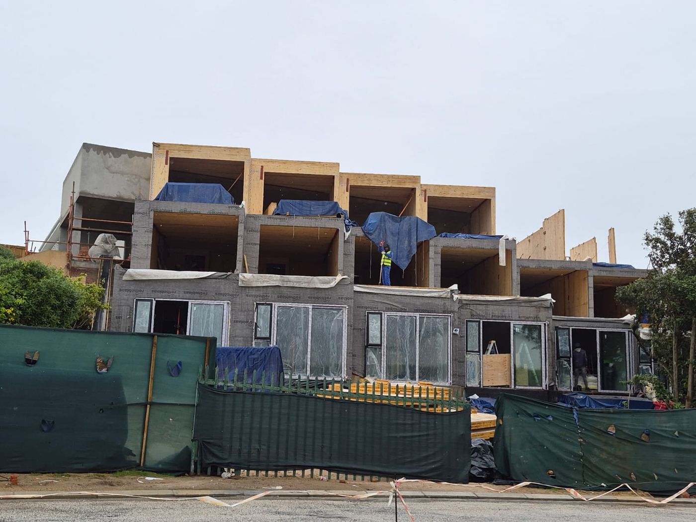 Driftwood House under construction, with exposed laminated timber floors and walls above the ground storey