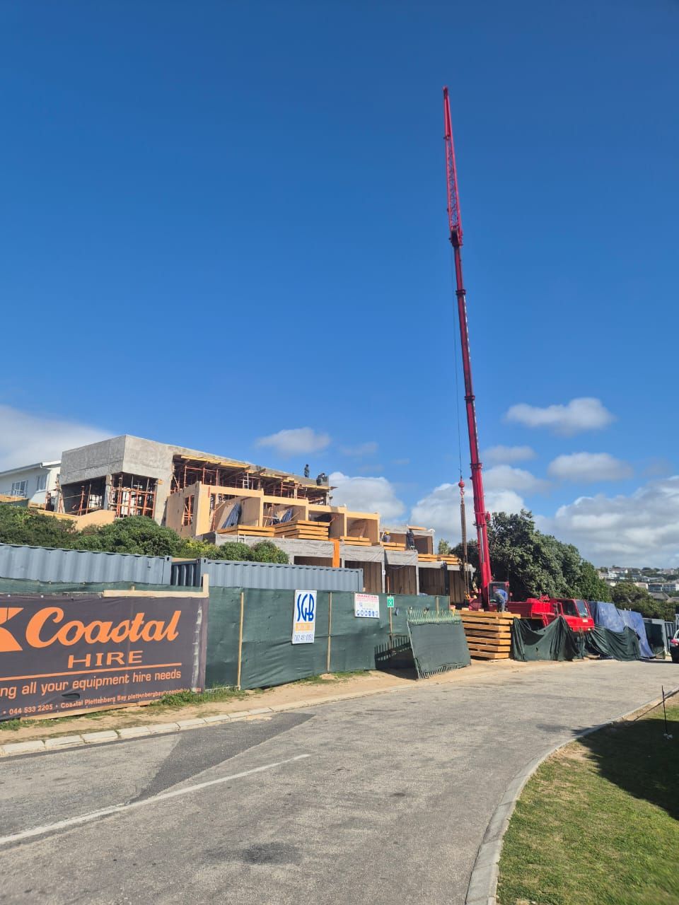 Street view of the Driftwood House site with the crane at work