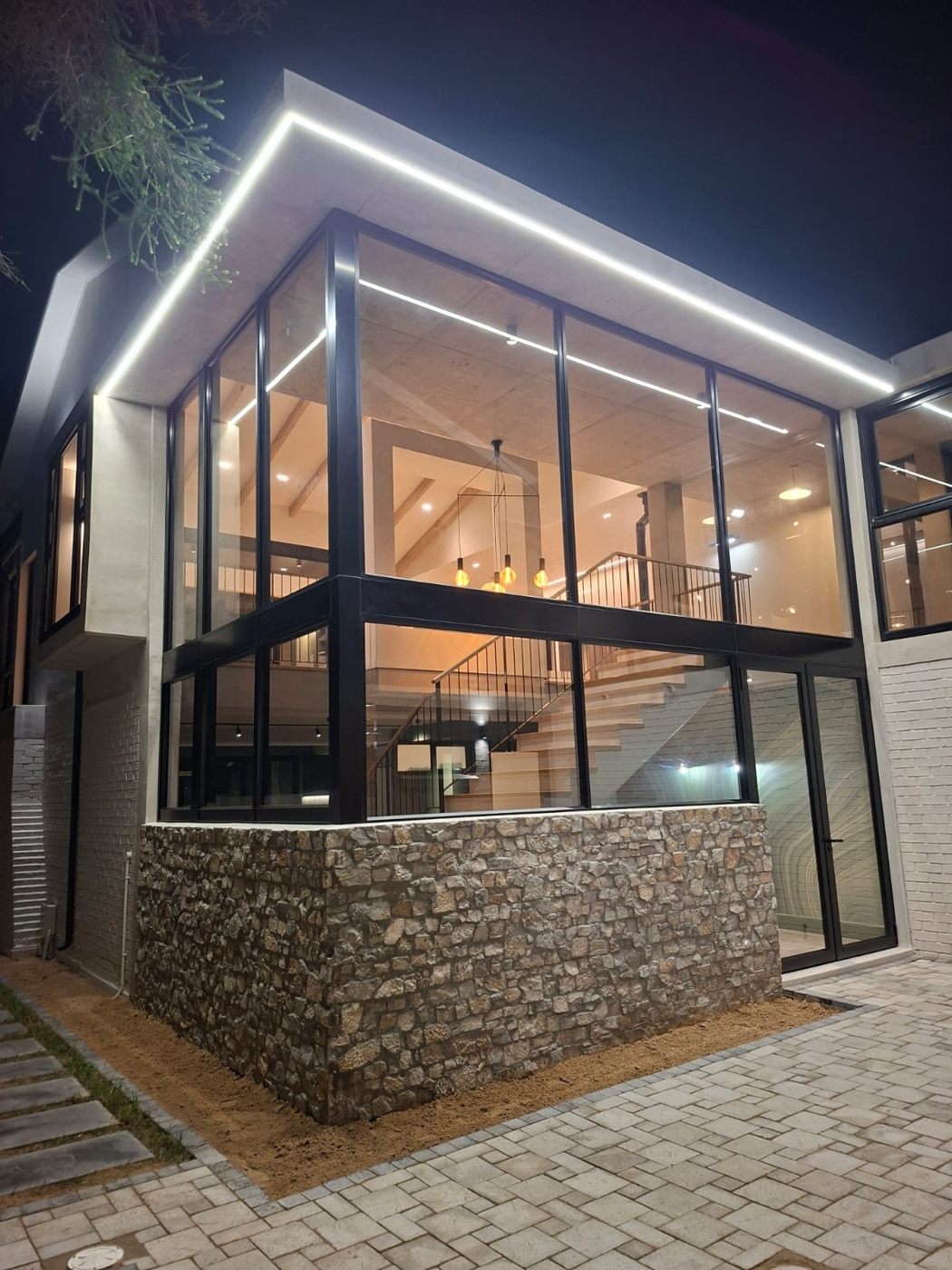 Illuminated glazed addition at House - Linkside at night