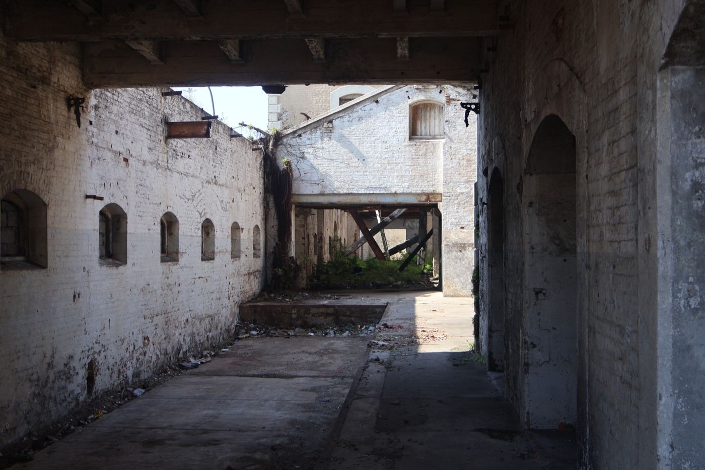 Roofless whitewashed interior of the mill opening onto an inner yard