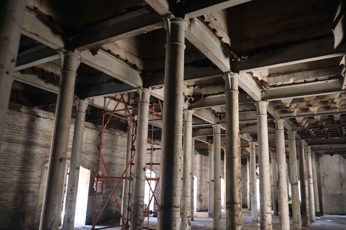 A forest of cast columns and beams supporting the silos, with scaffolding in place